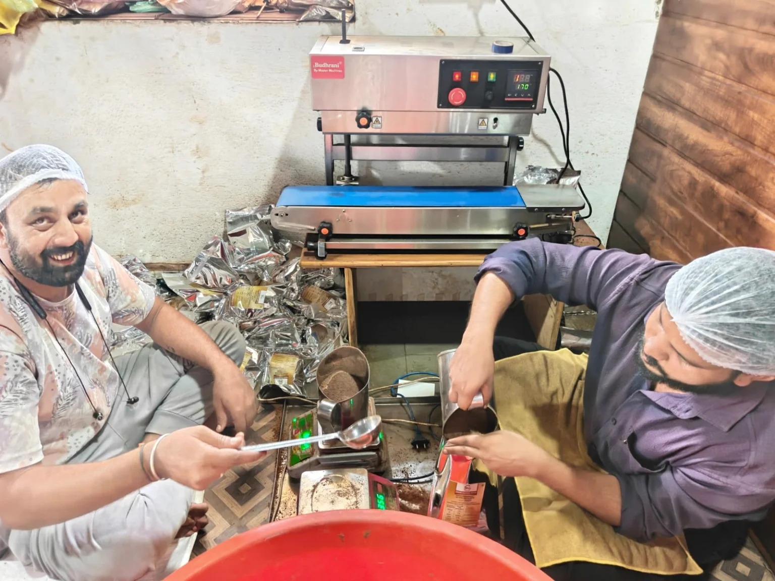 PNG Associates production team working beside sealing equipment